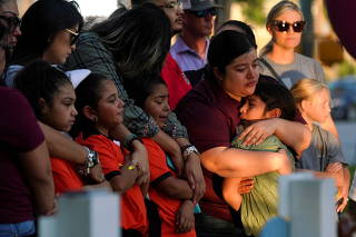 People mourn victims of the Robb Elementary School mass shooting, in Uvalde, Texas