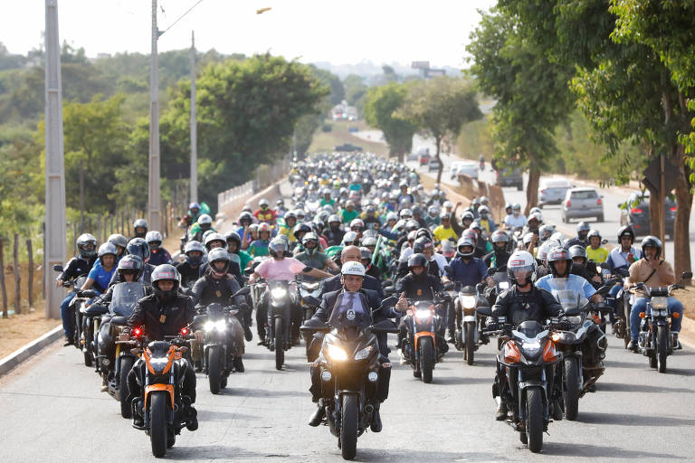O presidente Jair Bolsonaro lidera motociata em Goiânia; ele está no centro da foto, sobre uma moto, e há dezenas de motocicletas ao redor dele