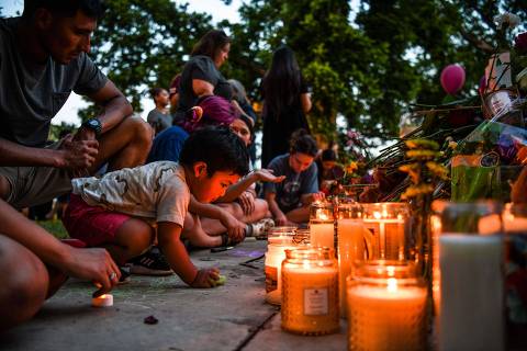 People light candles and lay flowers at a makeshift memorial outside the Uvalde County Courthouse in Uvalde, Texas on May 27, 2022. (Photo by CHANDAN KHANNA / AFP)