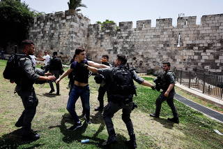 Israeli border policemen clash with a Palestinian man near Damascus gate to Jerusalem's Old City