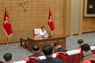 North Korean leader Kim Jong Un speaks at a politburo meeting of the Worker's Party on the country's coronavirus disease (COVID-19) outbreak response in Pyongyang