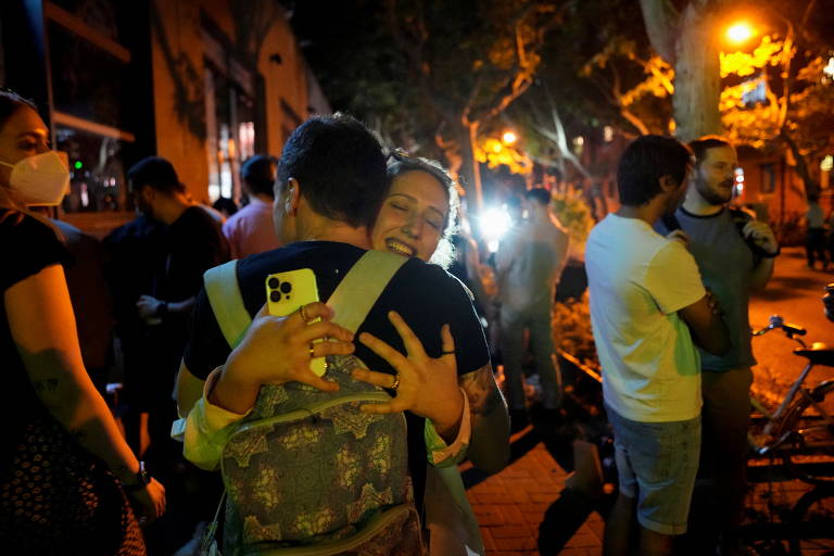 Pessoas se abraçam nas ruas de Xangai, na China, após governo encerrar lockdown de dois meses