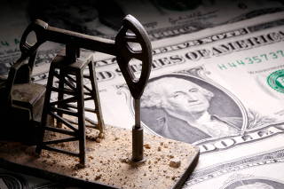 FILE PHOTO: A 3D-printed oil pump jack is placed on dollar banknotes in this illustration picture