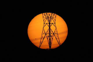 Pylons of high-tension electricity power lines are seen during sunset in Brasilia