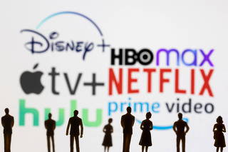 Toy figures of people are seen in front of the displayed Disney +, HBO Max, Apple TV, Netflix, Hulu and Prime logos, in this illustration
