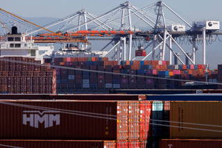 FILE PHOTO: Stacked containers are shown as ships unload their cargo at the Port of Los Angeles