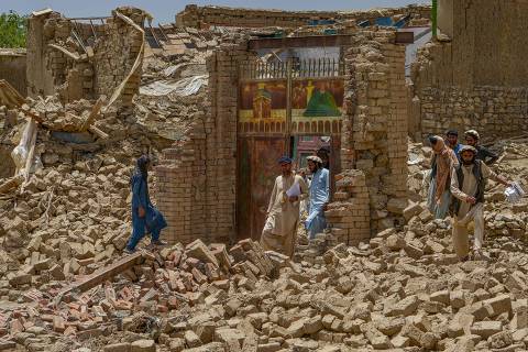 CORRECTION / Villagers along with rescue workers examine the extent of damage at a village following an earthquake in Bermal district, Paktika province, on June 23, 2022. - Desperate rescuers battled against the clock and heavy rain on June 23 to reach cut-off areas in eastern Afghanistan after a powerful earthquake killed at least 1,000 people and left thousands more homeless. (Photo by Ahmad SAHEL ARMAN / AFP) / The erroneous mention[s] appearing in the metadata of this photo by Ahmad SAHEL ARMAN has been modified in AFP systems in the following manner: [Bermal district] instead of [Bernal district]. Please immediately remove the erroneous mention[s] from all your online services and delete it (them) from your servers. If you have been authorized by AFP to distribute it (them) to third parties, please ensure that the same actions are carried out by them. Failure to promptly comply with these instructions will entail liability on your part for any continued or post notification usage. Therefore we thank you very much for all your attention and prompt action. We are sorry for the inconvenience this notification may cause and remain at your disposal for any further information you may require.
