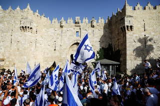FILE PHOTO: Israelis dance and sing while they hold Israeli national flags by Damascus Gate to Jerusalem's Old city