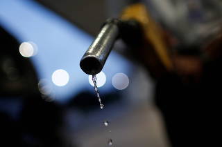 Gasoline drips from the nozzle of a fuel pump at a Brazilian oil company Petrobras gas station in Brasilia