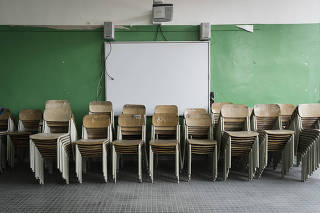 Stacked chairs at a school in Ponticelli, a district in the outskirts of Naples, Italy, on April 14, 2021. (Gianni Cipriano/The New York Times)