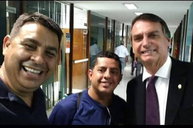 Marcelo de Arruda sorri ao lado de Jair Bolsonaro