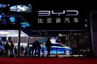 FILE PHOTO: People visit the BYD booth during a media day for the Auto Shanghai show