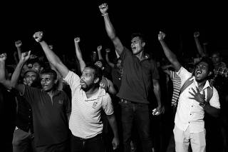People dance as they celebrate the resignation of Sri Lanka?s President Gotabaya Rajapaksa at a protest site, amid the country?s economic crisis, in Colombo
