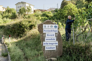 A sign refers to the Guinness record of the long-living Melis family in Perdasdefogu, Sardinia island, on June 9, 2022. (Gianni Cipriano/The New York Times)