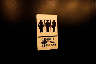 FILE PHOTO: A sign is seen on a gender neutral restroom wall in New York City