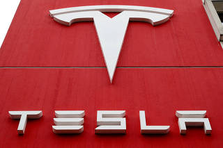 FILE PHOTO: FILE PHOTO: The logo of car manufacturer Tesla is seen in Bern