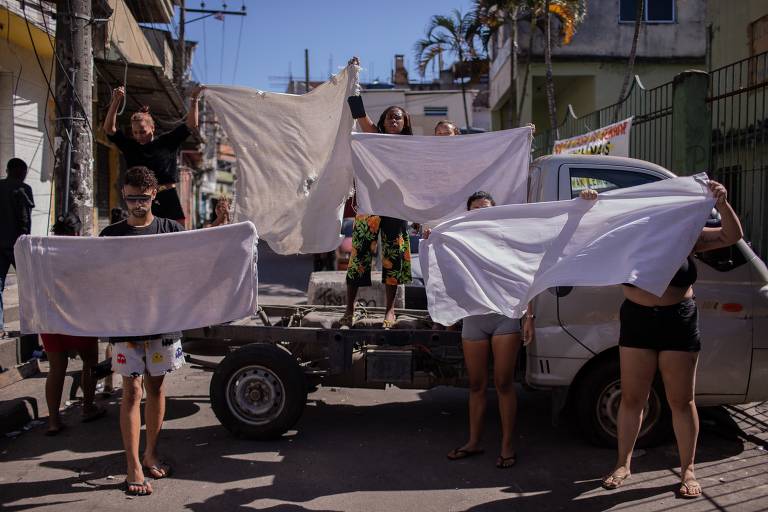 Moradores usam as toalhas e cobertores que carregaram os corpos dos mortos para pedir paz no Alemão; com base em informações fornecidas por unidades de saúde da região, havia 15 corpos na UPA (Unidade de Pronto-Atendimento) do Alemão e 5 no Hospital Estadual Getúlio Vargas.