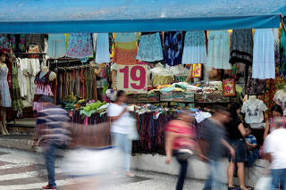 FILE PHOTO: People walk in front of a store on a commercial street in downtown Sao Paulo