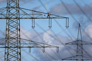 A specialist works at high voltage power lines near Kaarst