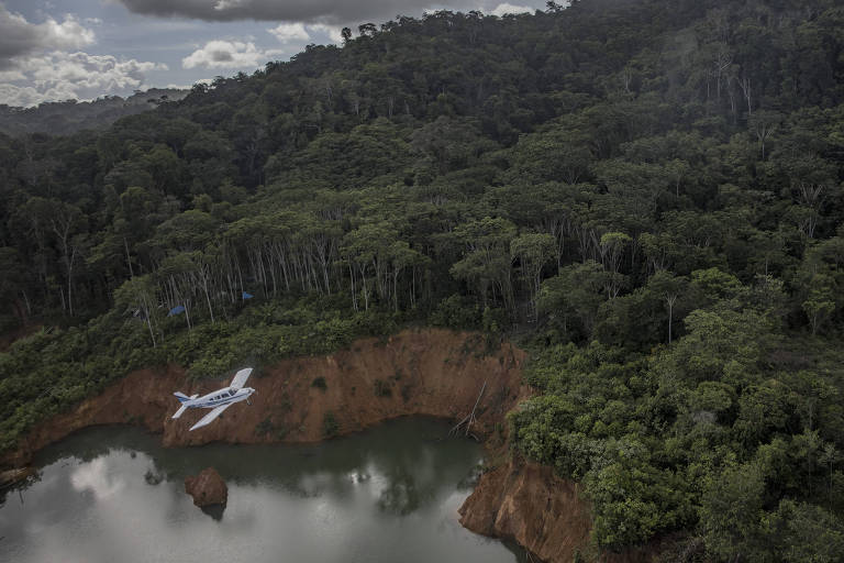 Aeronave sobrevoa uma mina ilegal em terra yanomami; o New York Times identificou centenas de pistas irregulares na Amazônia brasileira