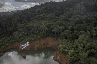 An airplane over a site of illegal mining in the land of the Yanomami people, in Roraima State, Brazil, on May 14, 2022. (Victor Moriyama/The New York Times)