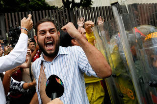 FILE PHOTO: Juan Requesens, deputy of the Venezuelan coalition of opposition parties (MUD), clashes with Venezuela's National Guards during a protest outside the Supreme Court of Justice (TSJ) in Caracas