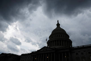 FILE PHOTO: Storm clouds pass over the U.S. Capitol in Washington