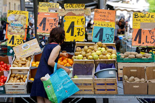 FILE PHOTO: Price tags are seen as a woman shops at a local market in Nice