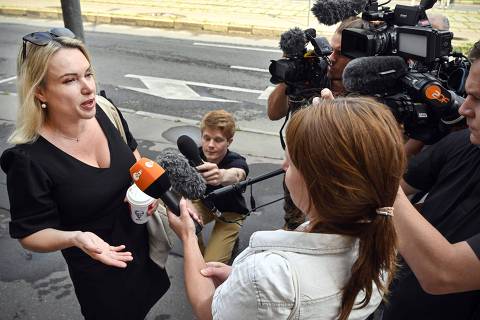 Marina Ovsyannikova, a journalist who became known after protesting against the Russian military action in Ukraine during a prime-time news broadcast on state television, answers journalists' questions as she arrives for her court session over charges of 