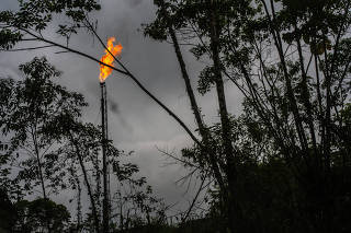 A gas flame burned at an oil well in Putumayo, Colombia on Feb. 6, 2022. (Federico Rios/The New York Times)