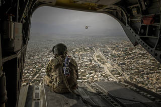 A U.S. Army helicopter over Kabul, Afghanistan, on May 2, 2021. (Jim Huylebroek/The New York Times)