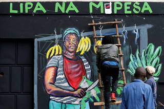 FILE PHOTO: An artist works on a mural advocating for retail M-Pesa mobile phone cashless payments in Nairobi