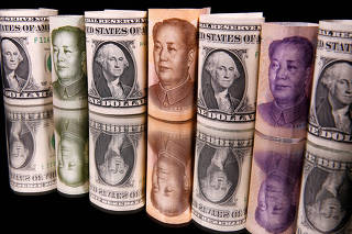 FILE PHOTO: Chinese Yuan and U.S. dollar banknotes are seen in this illustration