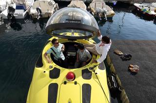 Visitors are seen aboard a U-boat Worx C-Quester submarine during the 23rd Monaco Yacht show in Monaco