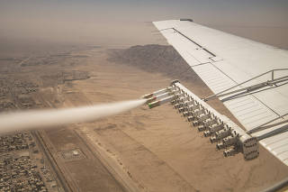 Experimental nanomaterial is released for the National Center of Meteorology and Seismology during a demonstration cloud seeding flight over in Al Ain, United Arab Emirates, March 3, 2022. (Bryan Denton/The New York Times)