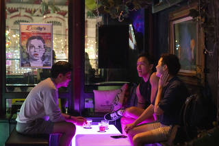 Patrons at a gay bar in Singapore, on Thursday, Aug. 25, 2022, after the government announced it would repeal a law banning consensual sex between men. (Ore Huiying/The New York Times)