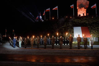 Soldiers and scouts hold torches during a ceremony to mark the 83rd anniversary of the outbreak of World War Two at Westerplatte Memorial in Gdansk