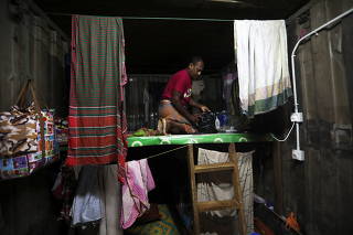 A Bangladeshi migrant worker on his upper deck bed in Kuala Lumpur