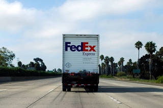 FILE PHOTO: Federal Express truck makes its way down a freeway in San Diego, California