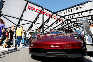 FILE PHOTO: People look at a Porsche Taycan during the Munich Auto Show in 2021