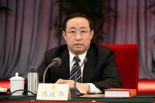 FILE PHOTO: Fu Zhenghua, then head of Beijing Municipal Public Security Bureau, is pictured during a meeting in Beijing