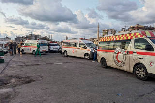 Ambulances are seen during the rescue process of migrants in the port of Tartous