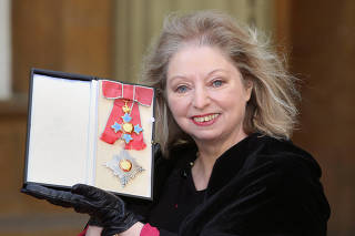 FILE PHOTO: Author Hilary Mantel poses with her Commander of the British Empire award at Buckingham Palace in London
