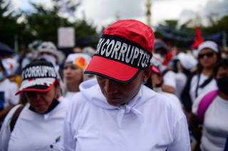 People take part in a protest against El Salvador's President Nayib Bukele in San Salvador