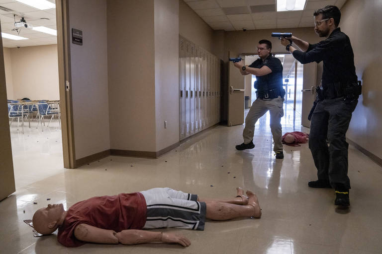Police officers in an active school shooter scenario at the State Preparedness Training Center in Oriskany, N.Y., June 29, 2022. The 1,100-acre, $50 million facility in upstate New York simulates a terrifying set of scenarios, from terrorist attacks to flash flooding. (Juan Arredondo/The New York Times)