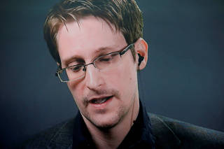 FILE PHOTO: Edward Snowden speaks via video link during a news conference in New York City