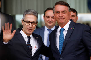 Governor of the state of Minas Gerais Romeu Zema greets Brazil's President and candidate for re-election Jair Bolsonaro during a news conference at the Alvorada Palace in Brasilia