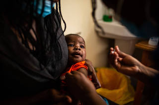 Simon Peter Ochieng receives his second of four malaria vaccine doses at Lumumba Hospital in Kisumu, Kenya, Dec. 8, 2021. (Kang-Chun Cheng/The New York Times)