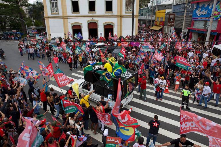 Apoiadores de Bolsonaro passam em meio a ato da campanha do ex-presidente Luiz Inácio Lula da Silva no centro de Guarulhos (SP) 