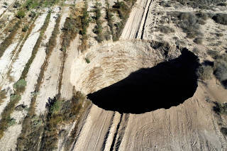 FILE PHOTO: A sinkhole is exposed close to Tierra Amarilla town, in Copiapo